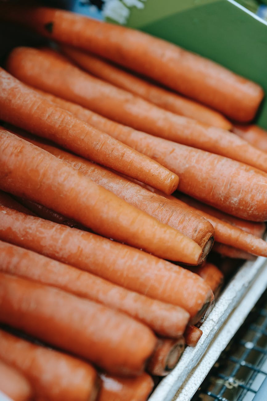 pile of whole fresh carrots in container